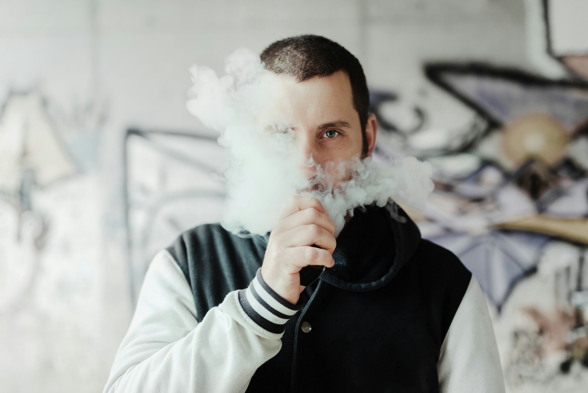 young man vaping his electronic cigarette